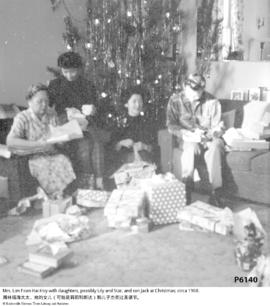 Mrs. Lim Foon Hai Hoy with daughters, possibly Lily and Star, and son Jack at Christmas; circa 1960.