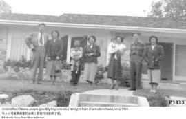 Unidentified Chinese people (possibly Hoy extended family) in front of a modern house; circa 1960.