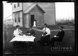 Portrait of group having tea in front of Hulbert house
